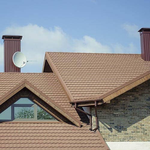 House with brown roof with large window